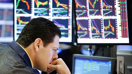 A specialist studies his screens as he works on the floor of the New York Stock Exchange, Friday, Oct. 10, 2008. 