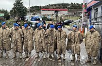 Turkish security forces stand guard next to parked ambulances at the entrance of an armament factory following an explosion in Balikesir, 24 December 2024