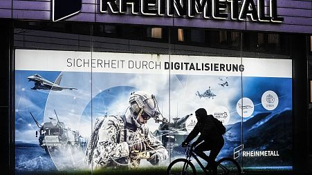 A man on a bicycle passes the headquarters of Germany's biggest arms manufacturer Rheinmetall AG in Duesseldorf, Germany