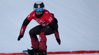 FILE - Switzerland's Sophie Hediger competes during the women's snowboard cross qualification round at the 2022 Winter Olympics, Feb. 9, 2022, in Zhangjiakou, China.