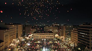 Athenians and tourists gather in Athens to release Christmas wishes on paper lanterns