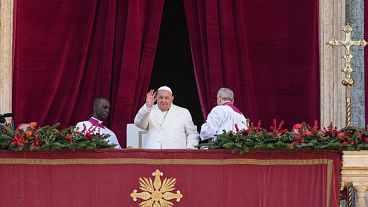 Pope Francis waves before delivering the Urbi et Orbi (Latin for 'to the city and to the world' ) Christmas' day blessing from the main balcony of St. Peter's Basilica at the 