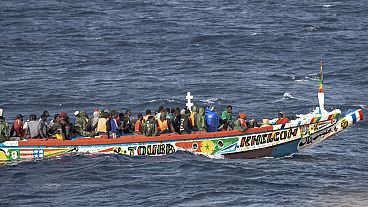 Migrants crowd a wooden boat as they sail to the port in La Restinga on the Canary island of El Hierro, Spain, Monday, Aug. 19, 2024. 