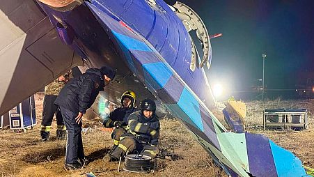 In this photo released by Kazakhstan's Emergency Ministry Press Service, rescuers work at the wreckage of Azerbaijan Airlines Embraer 190 lies on the ground near the airport.