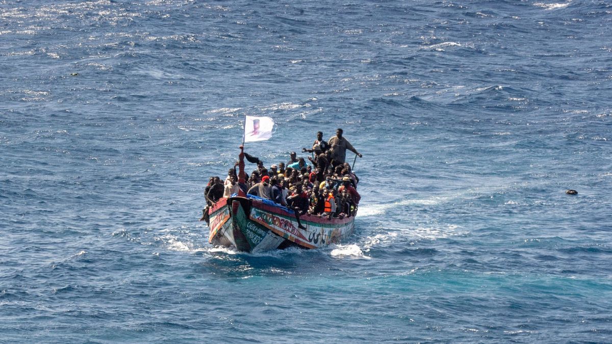 Migrants crowd a wooden boat as they sail to the port in La Restinga on the Canary Island of El Hierro, Spain, on 18 August 2024.