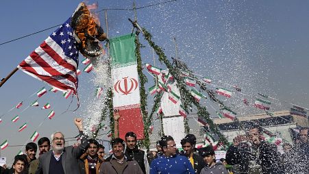 Demonstrators burn a US flag during their annual rally commemorating Iran's 1979 Islamic Revolution in Tehran, 11 February, 2024