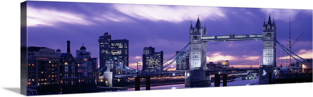 Spectacular panoramic view of the Tower Bridge, the River Thames and the skyline of London at night.