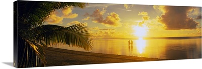 Silhouette of a couple standing on the beach, Aitutaki, Cook Islands, French Polynesia