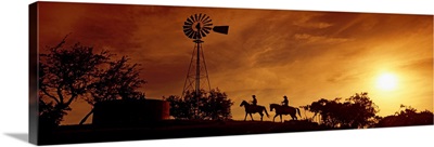 Silhouette of two horse riders at sunset, Hunt, Kerr County, Texas