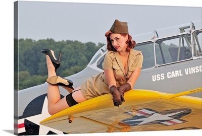 1940's style pin-up girl lying on a T-6 Texan training aircraft