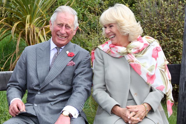 <p>King Charles, then-Prince of Wales and Queen Camilla, then-Duchess of Cornwall continue to laugh after a bubble bee took a liking to Prince Charles during their visit to the Orokonui Ecosanctuary on November 5, 2015</p>