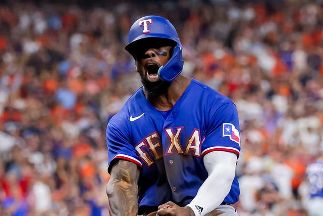 <p>Texas Rangers right fielder Adolis Garcia reacts after scoring against the Houston Astros</p>