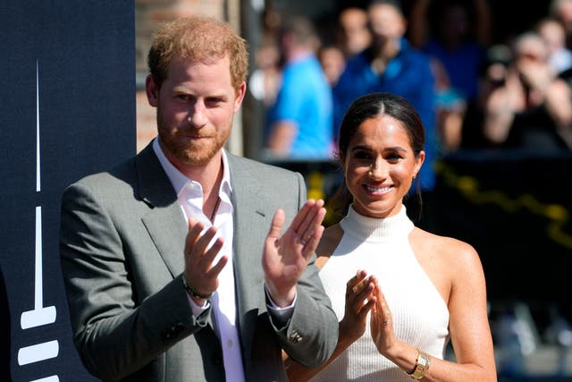 <p>Clap happy: Harry and Meghan on a visit to Dusseldorf </p>