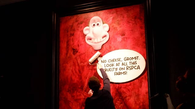 <h2><p>Animal Rising campaigners plastered Wallace and Gromit-themed posters onto the new painting</p></h2><p>
</p>