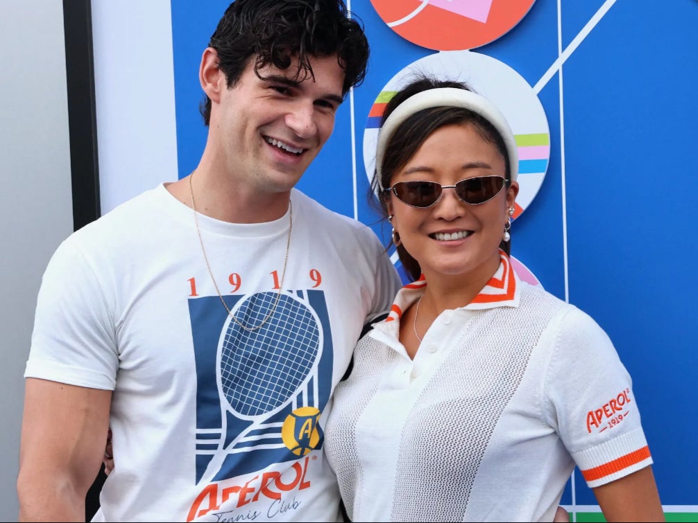 ‘Emily in Paris’ stars and real-life couple Ashley Park and Paul Forman don Aperol Spritz x US Open merch for the tournament