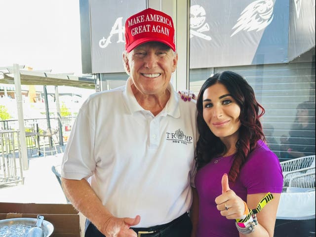 <p>Donald Trump and Laura Loomer pose at LIV golf event in August 2023</p>