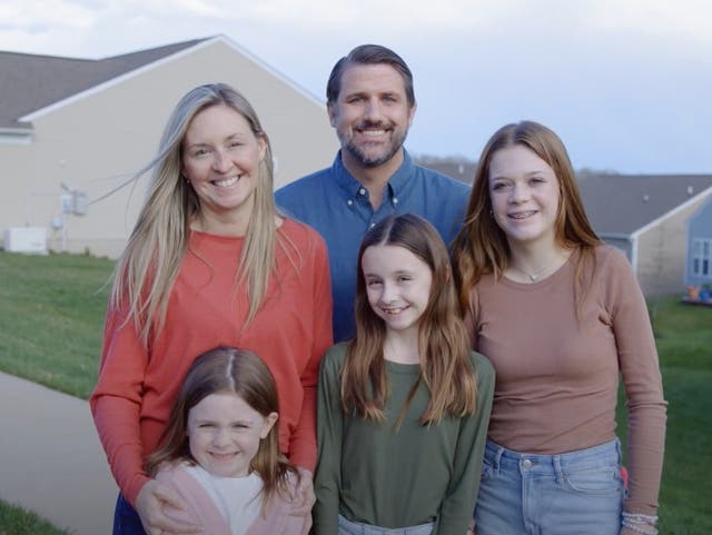 <p>Virginia congressional candidate Derrick Anderson poses for a photo to promote his campaign. These people are not his family </p>