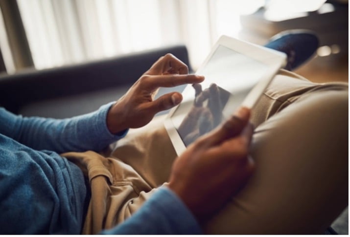 Closeup of someone interacting with a tablet device.