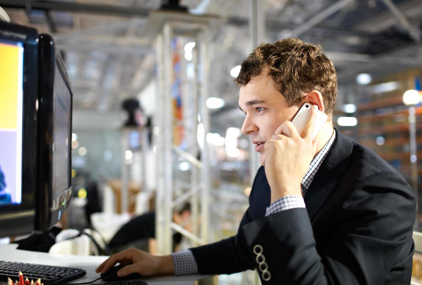 Man working and talking on the phone. photo