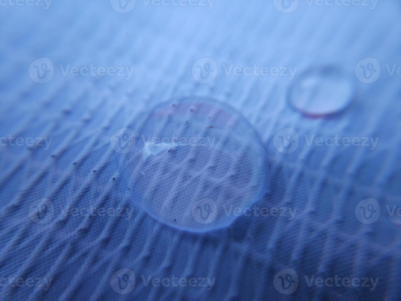 Water drop on fabric textured surface photo