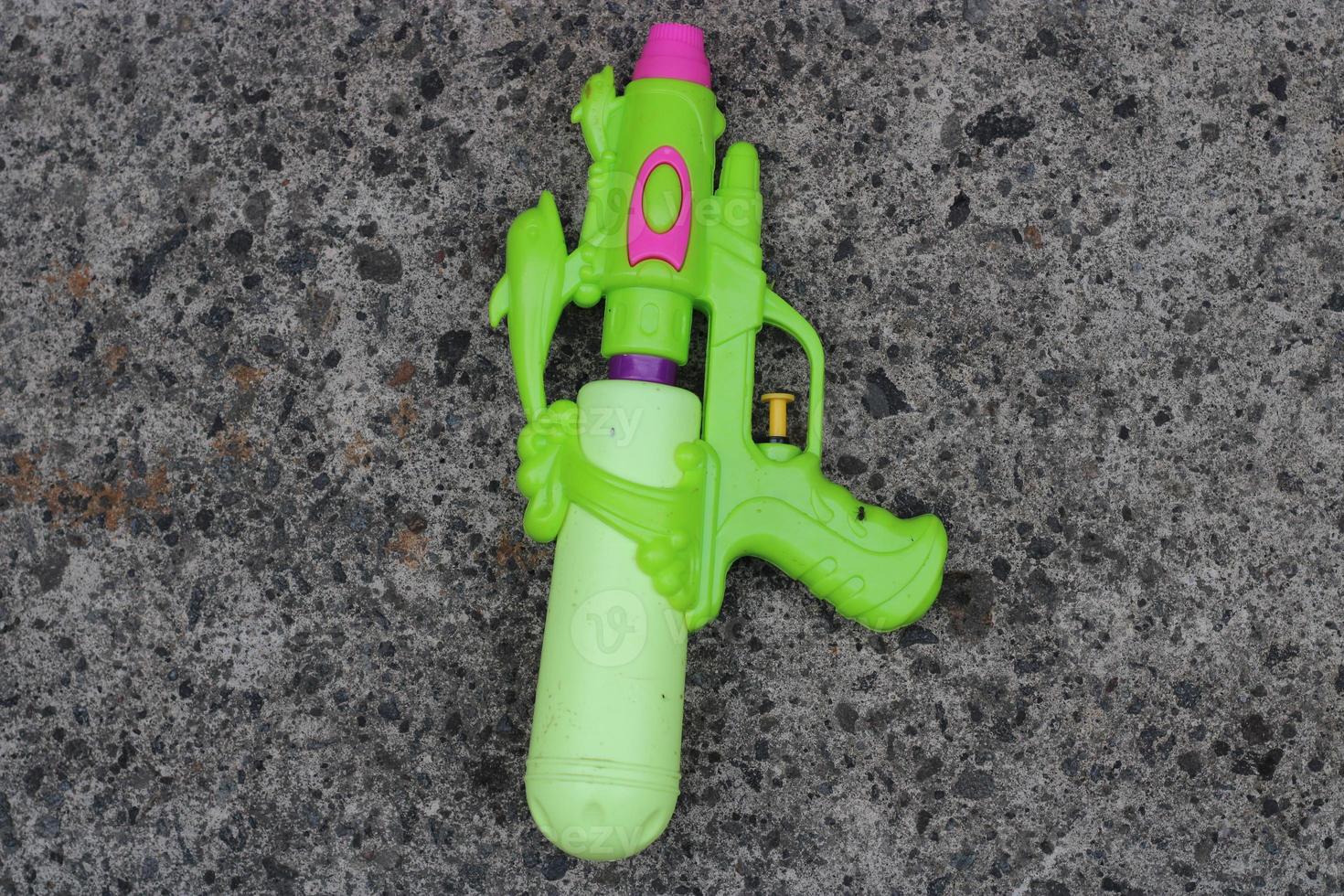 Photo of the green toy gun on the ground