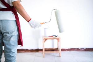 Close-up of a person holding a paint roller photo