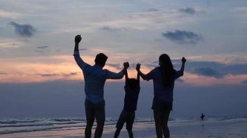 Silhouettes of asian family happy on the beach. video