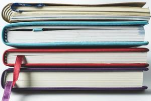 Close up stack of books on white background photo