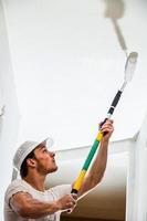 Closeup of Man Painting the Ceiling photo