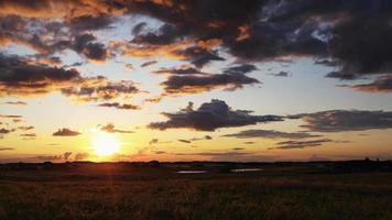 Sunset timelapse video. Sunset timelapse over the farmer's pasture in Alberta's Prairies, Canada. Blue sky with moving clouds. Canadian Prairies video