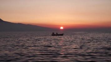 Fishing Boat Floating on The Ocean At Sunset. video