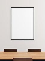 Minimalist vertical black poster or photo frame mockup on the wall in the office meeting room.