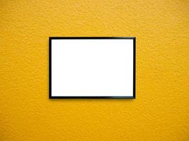 poster frame on yellow paint wall background photo