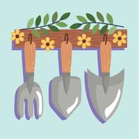 gardening tools hanging with flowers vector