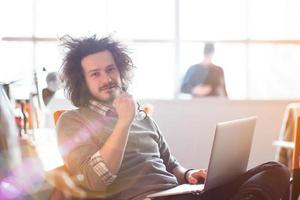 Young businessman using computer at work photo