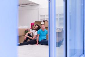 young  gay couple moving  in new house photo