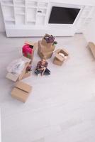 woman with many cardboard boxes sitting on floor photo