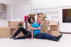 young  gay couple moving  in new house photo