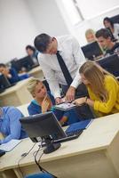 students with teacher  in computer lab classrom photo