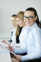 business woman standing with her staff in background photo