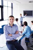 business man  on a meeting in offce with colleagues in background photo