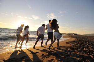 people group running on the beach photo