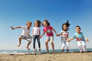 happy young  people group have fun on beach photo