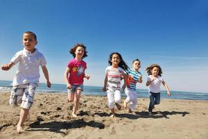 happy young  people group have fun on beach photo