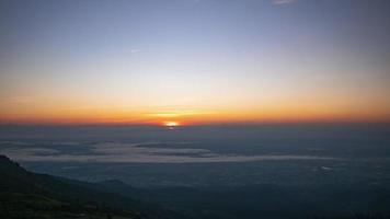 Timelapse Early morning, beauty of the rising sun and sunlight shines on clear sky, beautiful nature of forest and mountains in background video