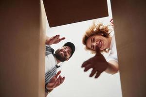 Playful mood. Happy couple together in their new house. Conception of moving photo