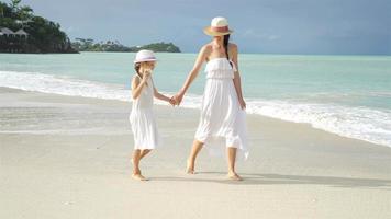 Family fun on white sandy beach. Mother and little kid enjoy summer vacation video