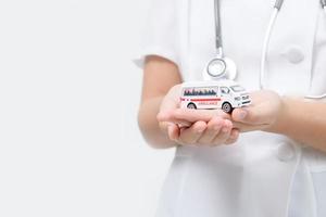 Ambulance model in doctor hand isolated on white background, photo