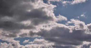 4k timelapse iridescent different layers of clouds in blue sky with glare from sun rays video