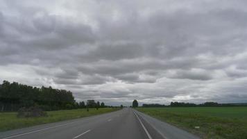 NOVOSIBIRSK, RUSSIA JUNE 23, 2021 - Driving along a motorway through green fields video